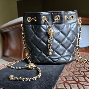 Black Quilted Mini Bucket Bag With Gold Chain And Leather Drawstring Adj Strap